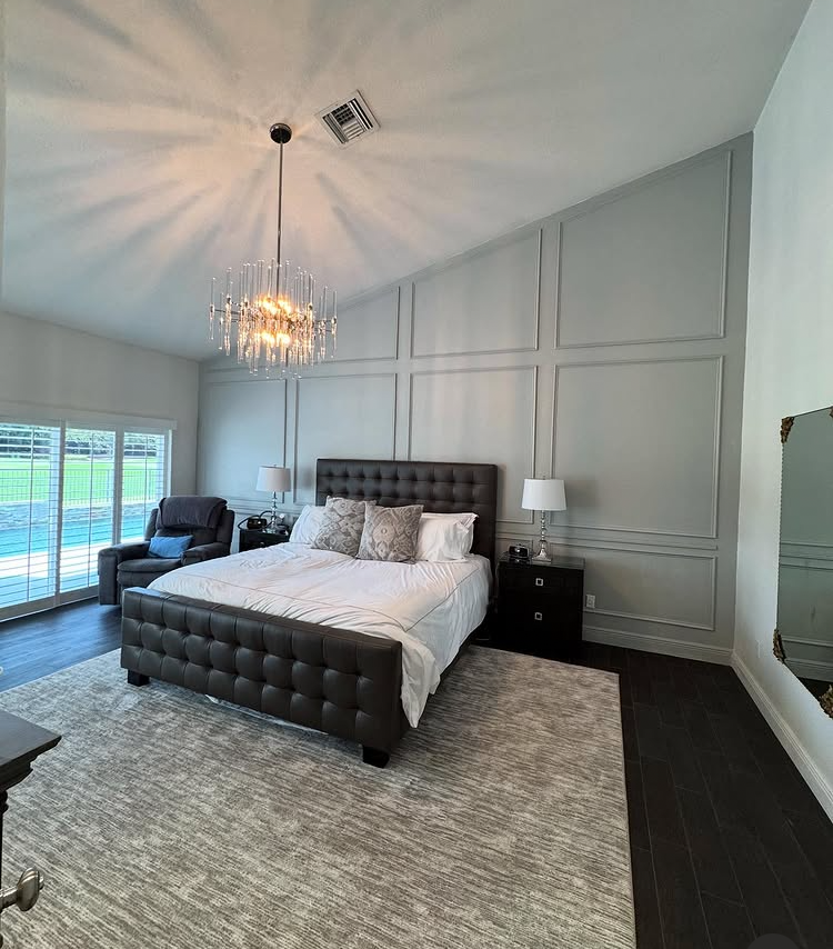 Bedroom with custom decorative wall molding and interior finish carpentry