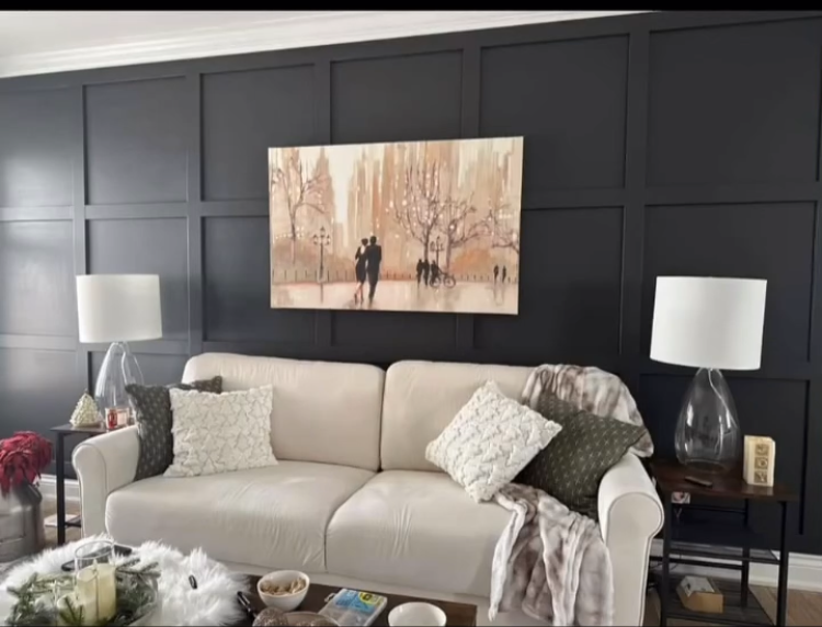 Living room with custom dark wood paneled accent wall and mounted television
